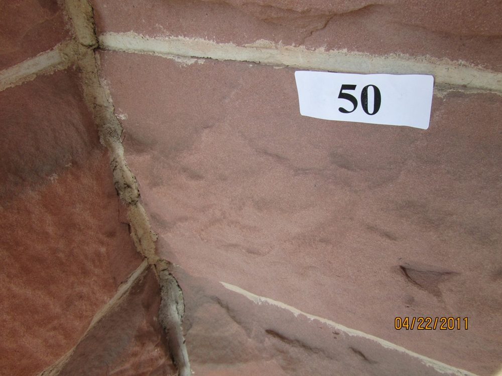 East wall sandstone before cleaning, showing surface dust and dirt