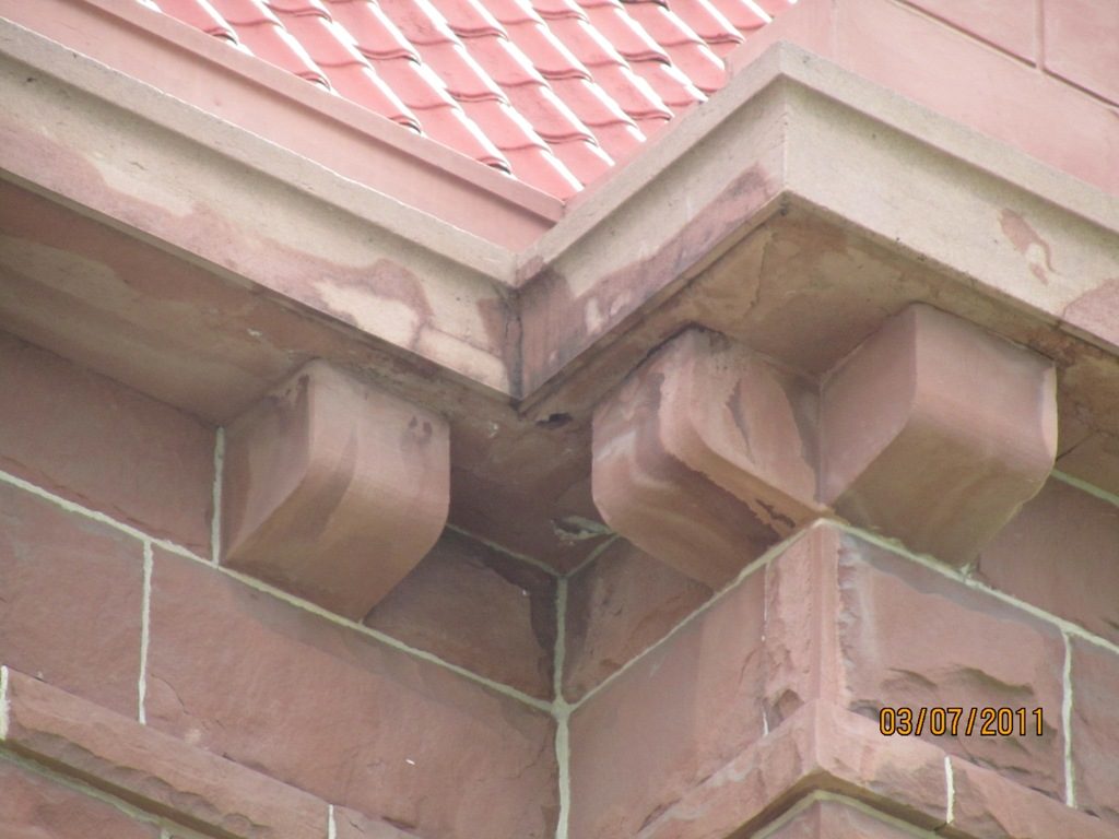 Row of sandstone corbels along the courthouse roof-line