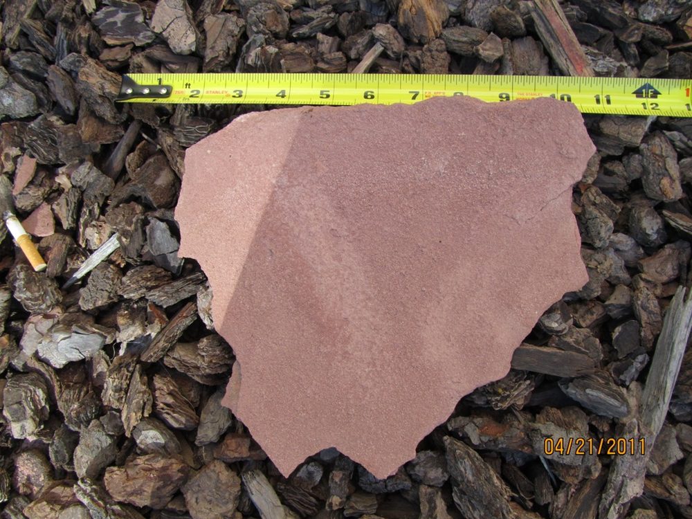 Delaminated sheet of sandstone that fell from the West wall during the inspection