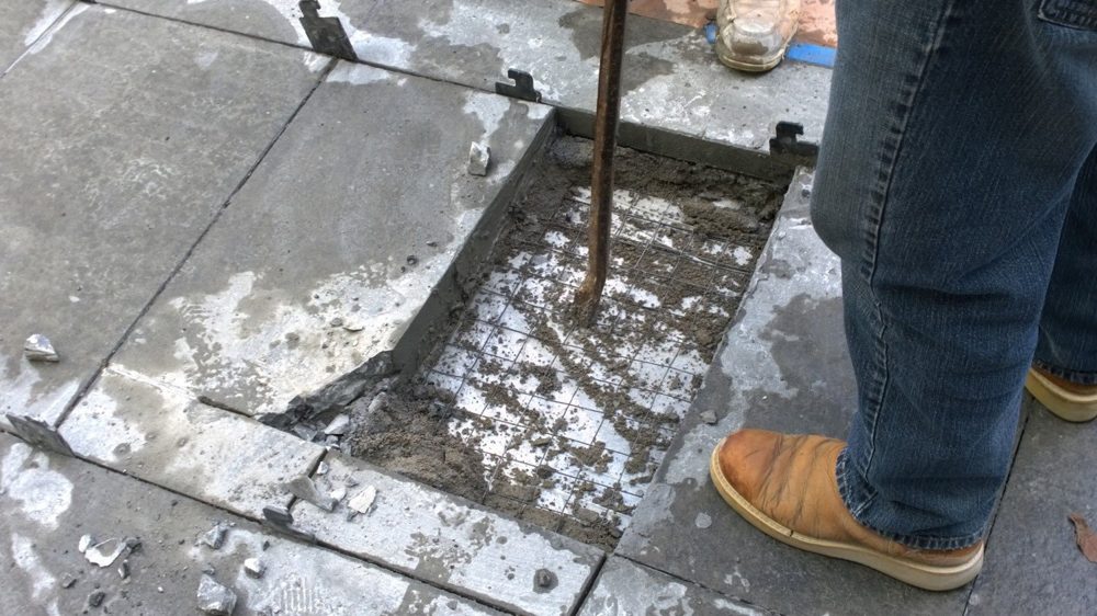 Destructive testing — stone removed to expose the setting bed